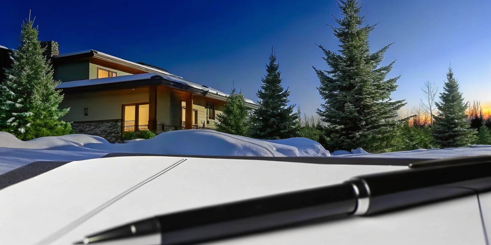 A 1099 worker plans an investment property jumbo loan with a notebook in front of a modern home.